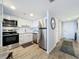 Bright kitchen with white cabinets, stainless steel appliances and wood floors at 400 E Colonial Dr # 1501, Orlando, FL 32803