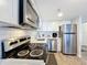 This kitchen features stainless steel appliances, white cabinets, and subway tile backsplash at 400 E Colonial Dr # 1501, Orlando, FL 32803