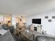 Open concept living room with modern decor, a large screen television, and comfortable seating at 400 E Colonial Dr # 1501, Orlando, FL 32803
