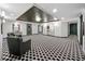 Grand lobby featuring unique black and white floors with artwork, seating, and an exit door at 400 E Colonial Dr # 1501, Orlando, FL 32803