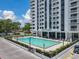 Exterior swimming pool outside of the Park Lake Towers with lounge seating and sunny skies at 400 E Colonial Dr # 1501, Orlando, FL 32803
