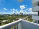 Enjoy a panoramic view of the city from this condo balcony, with lush green trees and clear blue skies at 400 E Colonial Dr # 1501, Orlando, FL 32803