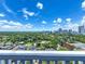 From this condo balcony, enjoy a stunning cityscape with lush green trees and fluffy clouds above at 400 E Colonial Dr # 1501, Orlando, FL 32803
