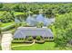Stunning waterfront home with lush landscaping, mature trees and serene lake views at 400 Timbercove Pl, Longwood, FL 32779