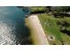 Aerial view of a sandy beach, dock, playground, and picnic area near the water at 400 Timbercove Pl, Longwood, FL 32779