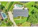 Aerial view of home with private pool, manicured landscaping, and circular driveway at 400 Timbercove Pl, Longwood, FL 32779