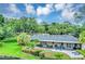 Backyard view of a home with a pool and landscaped yard by a lake at 400 Timbercove Pl, Longwood, FL 32779