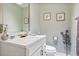 Well-lit half bathroom featuring modern fixtures, a white vanity, and tasteful decor with a clean and stylish design at 400 Timbercove Pl, Longwood, FL 32779