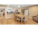 Bright and airy dining room with hardwood floors, a glass-top table, and seamless access to the kitchen at 400 Timbercove Pl, Longwood, FL 32779