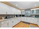 Modern kitchen featuring white cabinets, granite countertops, stainless steel appliances, and hardwood floors at 400 Timbercove Pl, Longwood, FL 32779