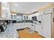 Bright kitchen with white cabinets, granite countertops, modern appliances, and hardwood floors at 400 Timbercove Pl, Longwood, FL 32779