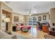 Comfortable living room with hardwood floors, a cozy seating area, and a view of the pool through glass doors at 400 Timbercove Pl, Longwood, FL 32779