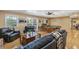Inviting living room featuring hardwood floors, cozy seating, and a billiard table in the background for relaxation at 400 Timbercove Pl, Longwood, FL 32779