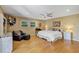 Spacious main bedroom with hardwood floors, a ceiling fan, ample natural light, and a comfortable seating area at 400 Timbercove Pl, Longwood, FL 32779