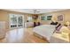 Serene main bedroom with hardwood floors, French doors, and a view of the lake at 400 Timbercove Pl, Longwood, FL 32779
