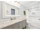 Bathroom vanity with granite countertop, white cabinets, and decorative mirror at 417 Monticello Dr, Altamonte Springs, FL 32701