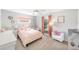 Charming bedroom with pink accents, a window view and neutral carpeting at 417 Monticello Dr, Altamonte Springs, FL 32701