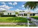 Charming front exterior featuring a green yard, a brick house, and black shutters at 417 Monticello Dr, Altamonte Springs, FL 32701