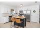 Bright kitchen with white cabinets, stainless steel appliances, granite counters, and a central island with seating at 417 Monticello Dr, Altamonte Springs, FL 32701
