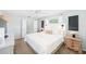 Bright bedroom with white bedding and decor, bedside tables and lamps at 417 Monticello Dr, Altamonte Springs, FL 32701