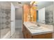 Well lit vanity area in bathroom, with tub and linen closet adjacent at 419 W Orange St, Altamonte Springs, FL 32714