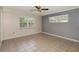 Empty bedroom features tile flooring, ceiling fan and two windows for ample natural light at 419 W Orange St, Altamonte Springs, FL 32714