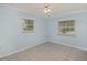 Simple bedroom with tile flooring, two windows, and a ceiling fan at 419 W Orange St, Altamonte Springs, FL 32714