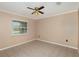 Neutrally painted bedroom with window and tiled flooring at 419 W Orange St, Altamonte Springs, FL 32714