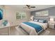Comfortable bedroom with a tufted headboard, bright natural light, and tile flooring at 419 W Orange St, Altamonte Springs, FL 32714