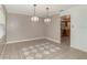 Open dining room with modern pendant lights, tile floors, and a view into the kitchen at 419 W Orange St, Altamonte Springs, FL 32714