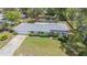 Charming home featuring a spacious front yard, mature landscaping, and a screened-in pool area at 419 W Orange St, Altamonte Springs, FL 32714