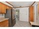 Traditional kitchen with stainless steel refrigerator, tile flooring and wood cabinets at 419 W Orange St, Altamonte Springs, FL 32714