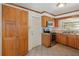 Functional kitchen with wooden cabinets, tile flooring, and modern stainless steel appliances at 419 W Orange St, Altamonte Springs, FL 32714