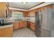Well-equipped kitchen with stainless steel appliances, oak cabinets, and tile flooring at 419 W Orange St, Altamonte Springs, FL 32714