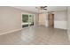 Bright living room featuring tiled floors and sliding glass doors to screened patio at 419 W Orange St, Altamonte Springs, FL 32714