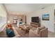 Cozy living room with neutral tones, a large TV, and a dining area in an open floor plan at 419 W Orange St, Altamonte Springs, FL 32714