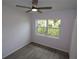 Bedroom showcasing wood-look floors, a window view, and a ceiling fan at 438 Romano Ave, Orlando, FL 32807