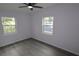 Bright bedroom featuring laminate flooring, neutral walls and two large windows at 438 Romano Ave, Orlando, FL 32807