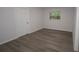 This bedroom features wood-look floors, window and white walls at 438 Romano Ave, Orlando, FL 32807