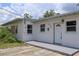 Charming single-story home displaying a freshly painted exterior and a welcoming front porch at 438 Romano Ave, Orlando, FL 32807