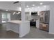 Well-lit kitchen with stainless steel appliances, white cabinets, island and modern lighting at 438 Romano Ave, Orlando, FL 32807