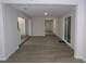 Open concept living room featuring modern gray flooring and a bright, spacious feel at 438 Romano Ave, Orlando, FL 32807