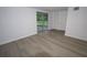 An interior room with sliding glass doors, wood-look floors, and neutral paint at 438 Romano Ave, Orlando, FL 32807
