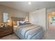 Comfortable bedroom featuring a padded headboard, soft carpeting, and stylish bedside tables at 5641 Brosnan Rd, St Cloud, FL 34771