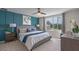 Serene bedroom with a large window, blue accent wall, comfortable bed, and stylish contemporary furnishings at 5641 Brosnan Rd, St Cloud, FL 34771