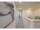 Upstairs hallway featuring neutral walls, carpeted floors, recessed lighting, and an attractive modern art piece at 5641 Brosnan Rd, St Cloud, FL 34771