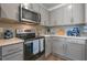 Well-equipped kitchen featuring modern appliances, ample countertop space, and sleek gray cabinetry at 5641 Brosnan Rd, St Cloud, FL 34771
