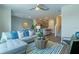 Comfortable living room features modern decor, gray sectional sofa, and an open floor plan to the kitchen at 5641 Brosnan Rd, St Cloud, FL 34771