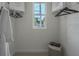 Practical walk-in closet with shelving and hanging rods, providing organized storage space and a window view at 5641 Brosnan Rd, St Cloud, FL 34771