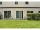 Private backyard featuring a patio, well-kept lawn, and manicured hedges, ideal for relaxation at 600 Northern Way # 607, Winter Springs, FL 32708